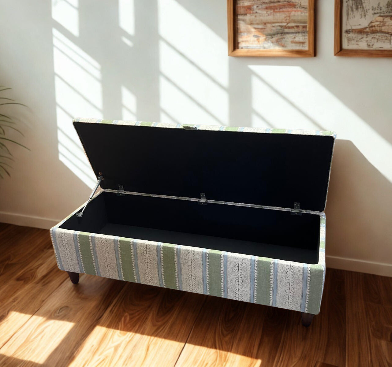 Striped storage bench with open lid in a sunlit room