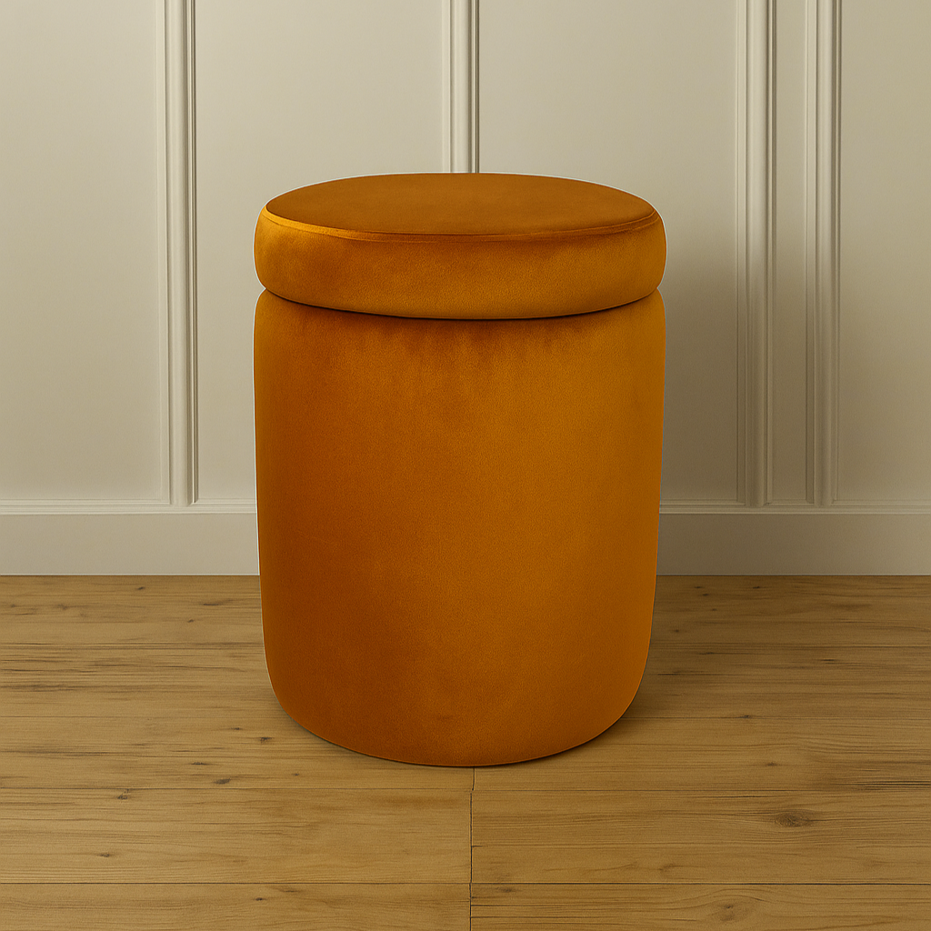 Orange cylindrical ottoman with removable lid against a neutral wall.