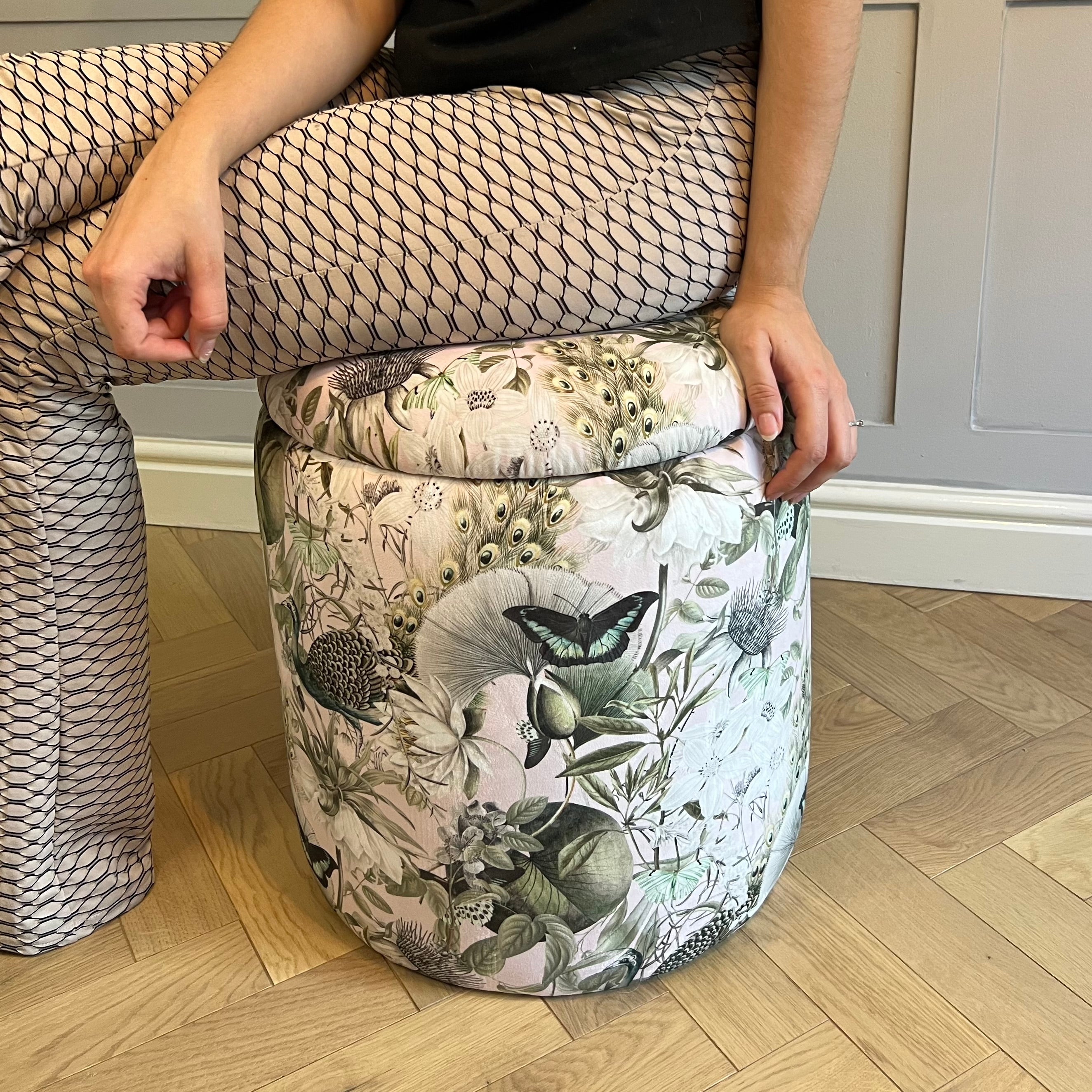someone sat on the pink utopia dressing table stool pouffe showing the thick comfortable lid seat