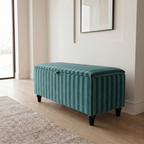 Modern hallway with a teal striped storage ottoman with black legs on a wooden floor