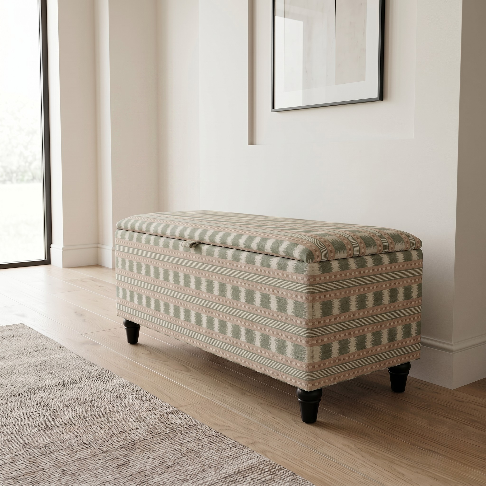 Elegant hallway with an upholstered storage bench seating in a stripe box Paxton James hare fabric and black feet. Stood on a wooden floor. 