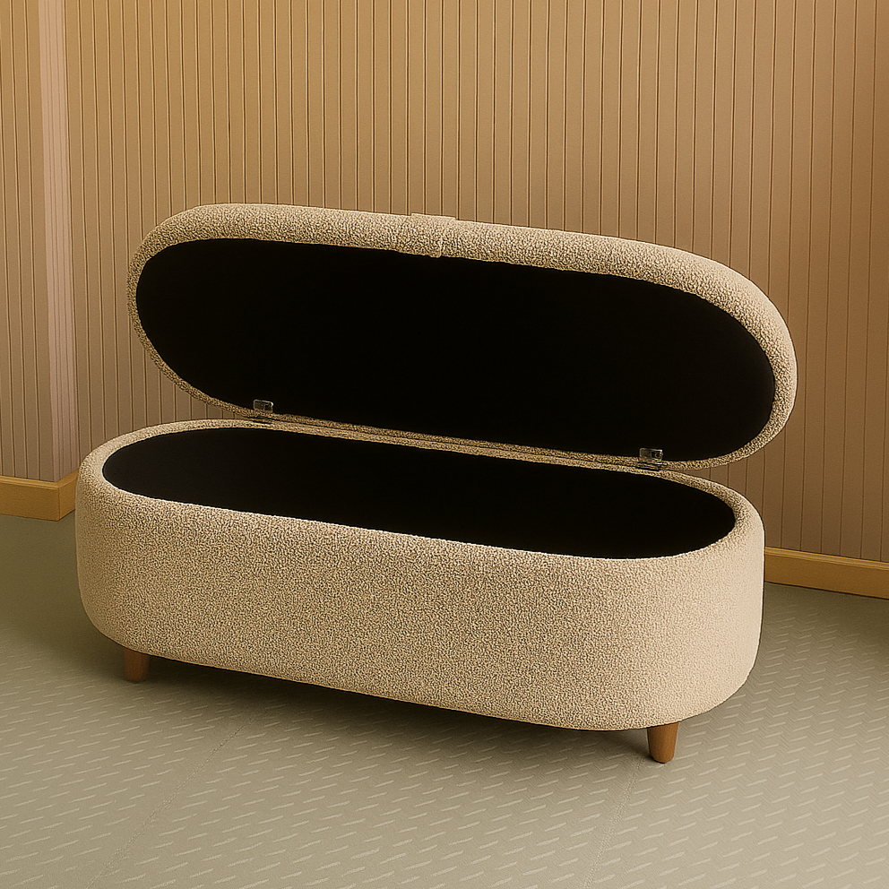 Beige storage ottoman with open lid against a wooden wall.