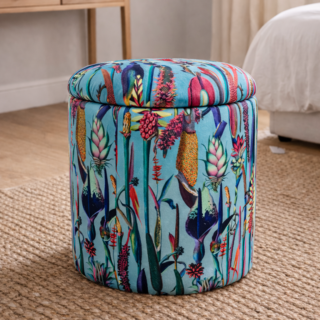 Colorful patterned ottoman in a room with a desk and window.