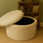 Round storage ottoman with an open lid in a room with a bookshelf and lamp.