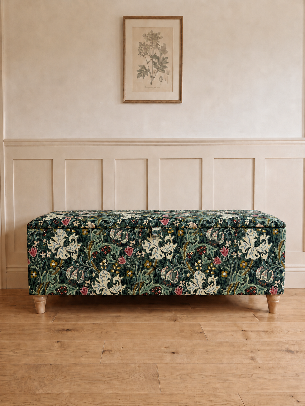 William Morris Golden Lily Dark Storage Ottoman Bench in a modern hallway with light wooden floors and panelled walls.