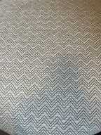 Textured fabric with a zigzag pattern in neutral beige tones with blue hints