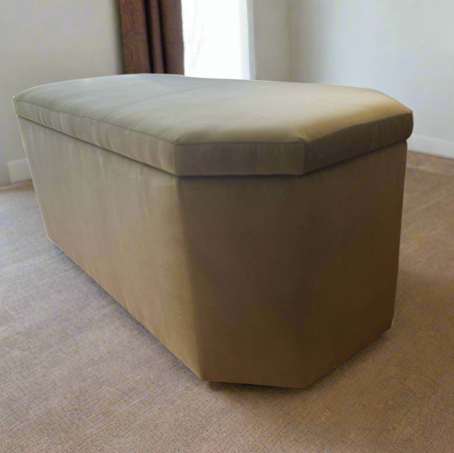green storage bench in a room with neutral decor.