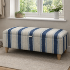 Blue Linwood Wavy Striped ottoman in a room with a window and plants