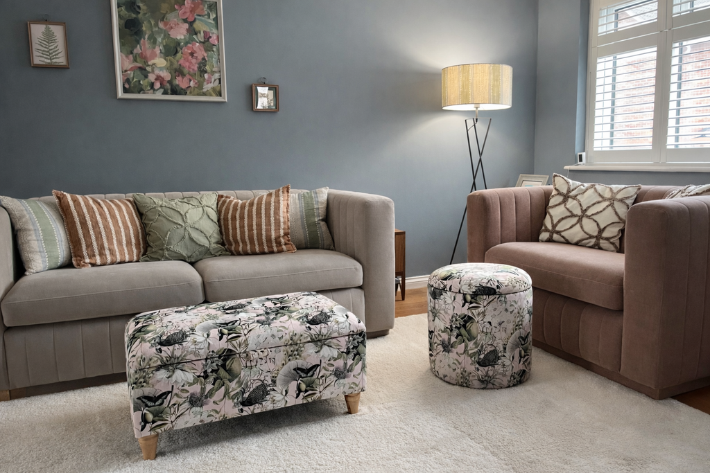 Living room with gray sofa, brown armchair, and Utopia Pink patterned storage ottomans.