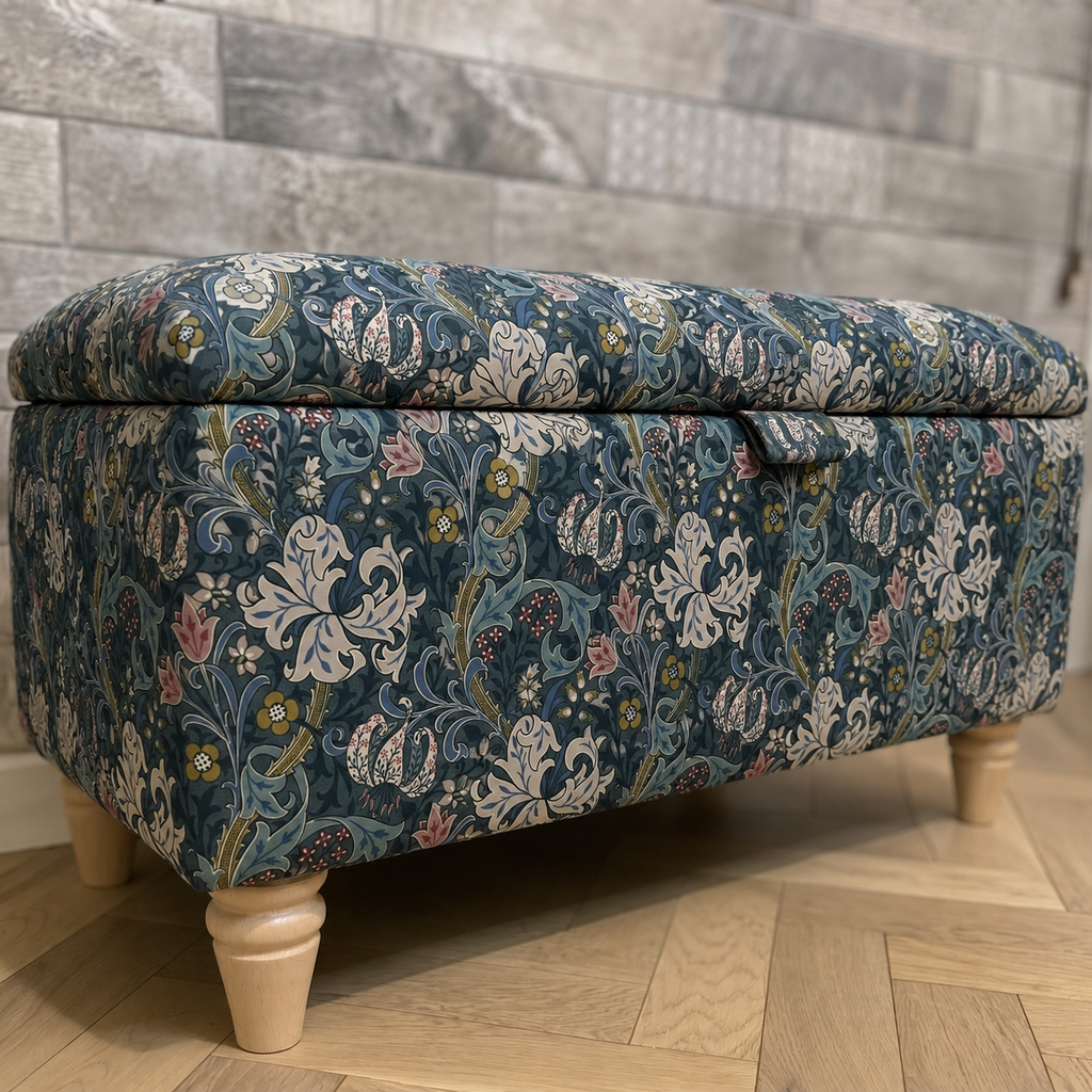William Morris Letchworth ottoman in golden lily velvet on a parquet wooden flooring with tiles behind