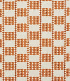 A close-up of a iLiv Flint fabric with a repeating geometric pattern of orange-brown diamond and square motifs on an off-white background.