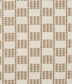 A close-up of a iLiv Flint fabric with a repeating geometric pattern in taupe brown on a warm off-white background.