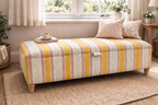 Linwood Yellow Wavy Striped ottoman with cushions in a living room setting