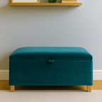 Teal ottoman in a room with a shelf and decorative items.