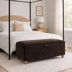 Bedroom with a four-poster bed and brown ottoman