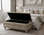 William Morris light beige patterned storage bench in a bedroom setting with a bed and lamps.