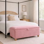 Bedroom with a four-poster bed and pink ottoman