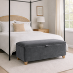 Bedroom with a four-poster bed and gray ottoman