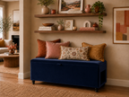 Navy blue storage bench with colorful pillows in a living room setting.
