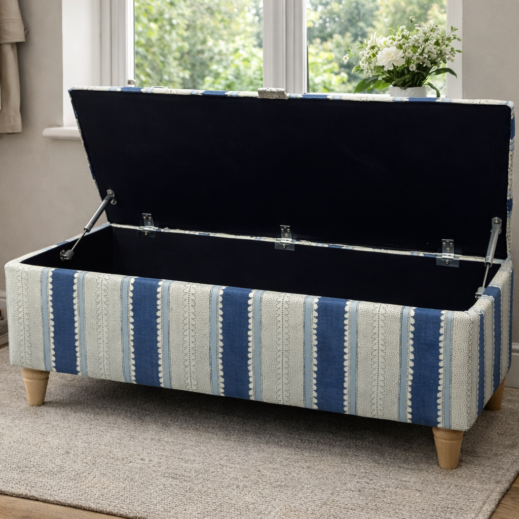 Blue Linwood Wavy Striped storage bench with open lid in a room with a window and shoes on the floor.