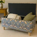 Floral-patterned storage bench with cushions in a room setting