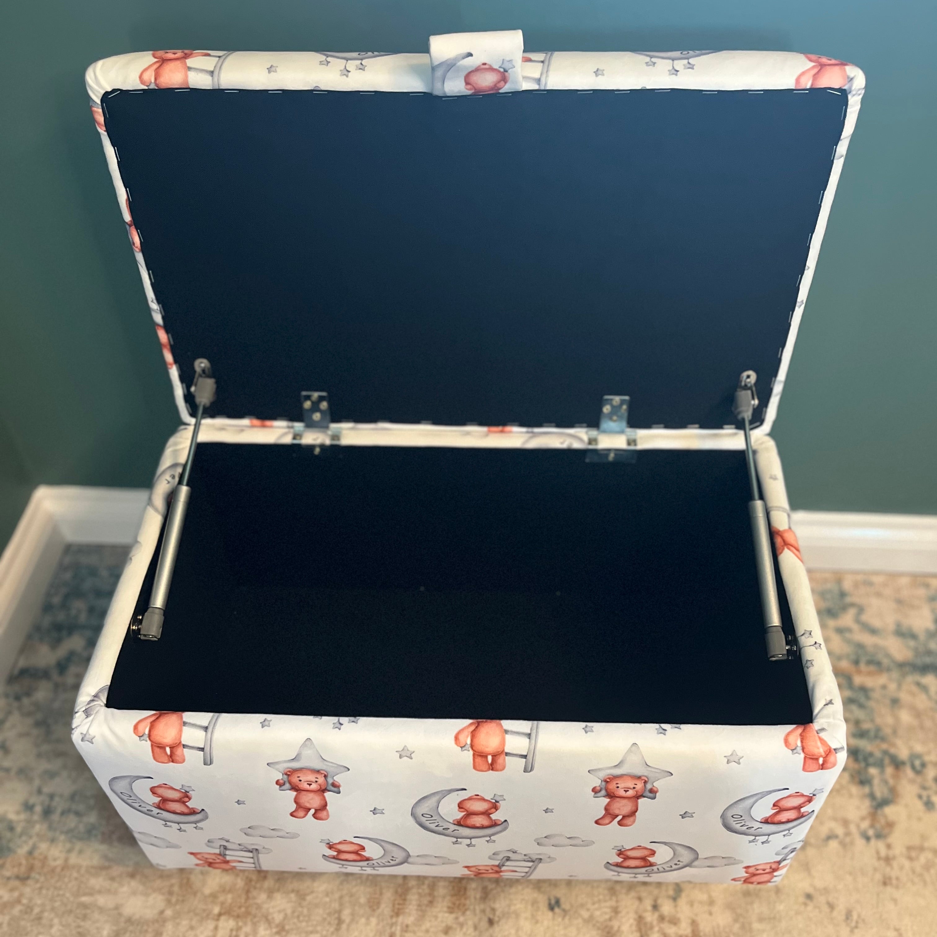 white custom name toy box with teddy bears on and moons on. The box is open with black fabric interior
