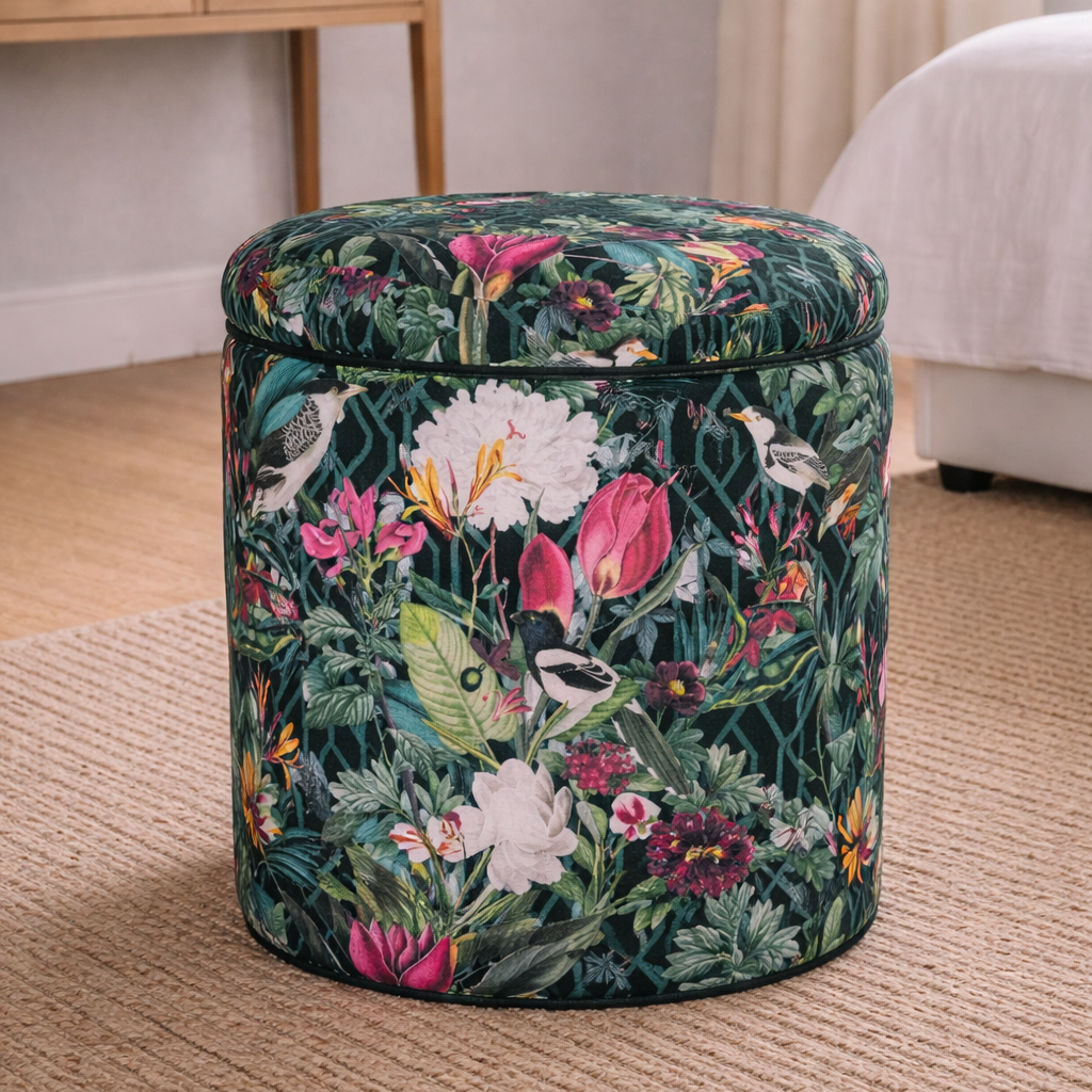 Floral-patterned ottoman in a room with a desk and bed.