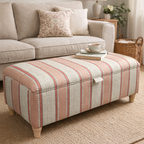 Living room with a pink wavy striped ottoman in Linwood fabrics, sofa, and decorative items.