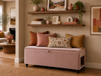 Pink velvet storage bench with a pat side opening and decorative pillows in a living room setting.