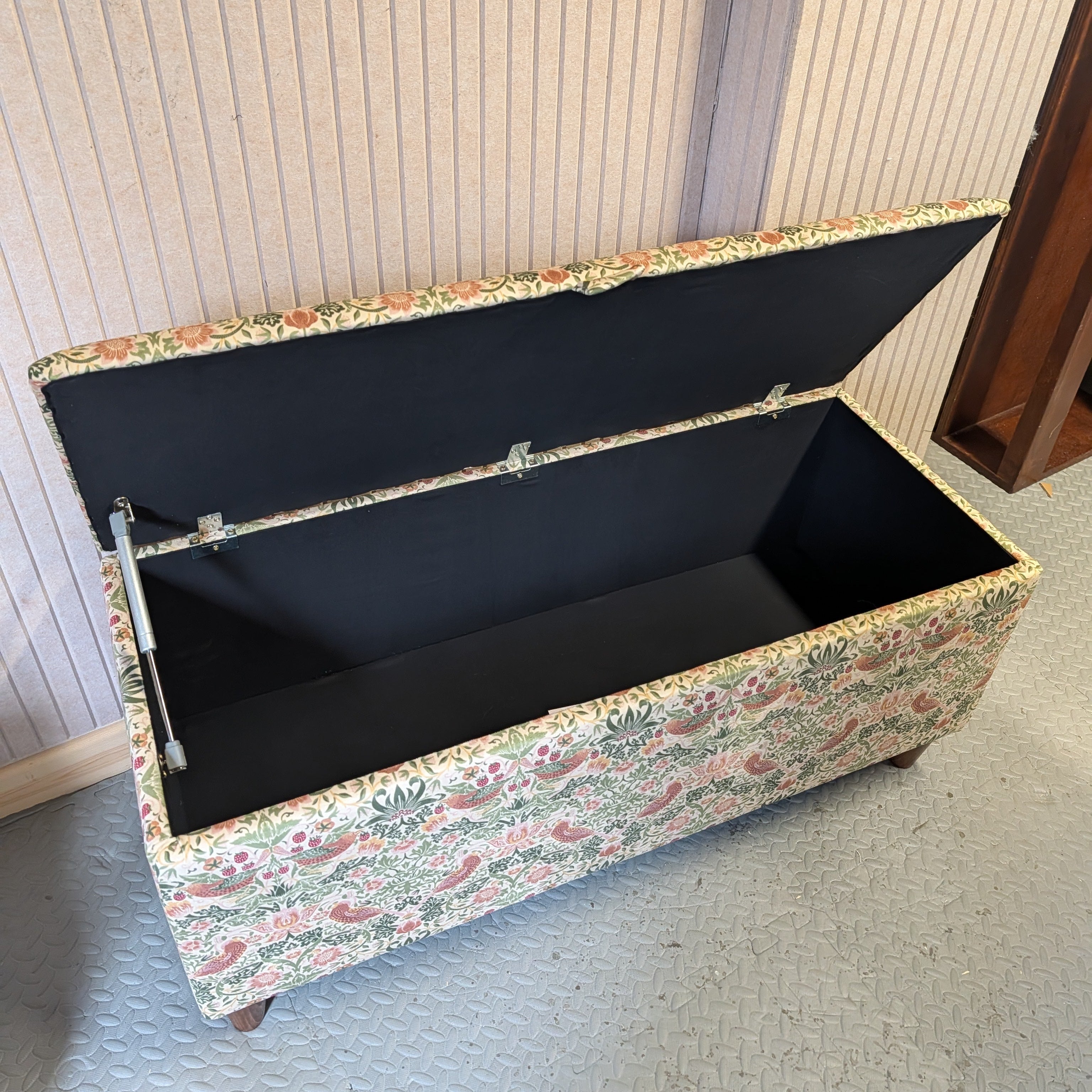 Floral-patterned William morris storage bench with open lid on a neutral background