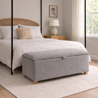 Bedroom with a canopy bed and gray ottoman