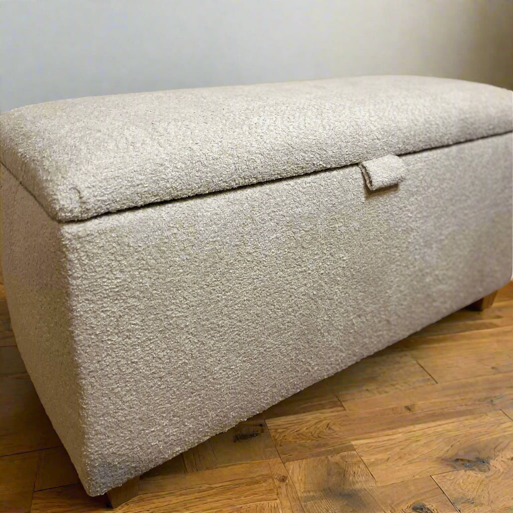 corner of teddy soft boucle ottoman trunk with lid and small wooden trapeze feet