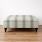 Linwood Dimity Striped ottoman on a wooden floor with a white background