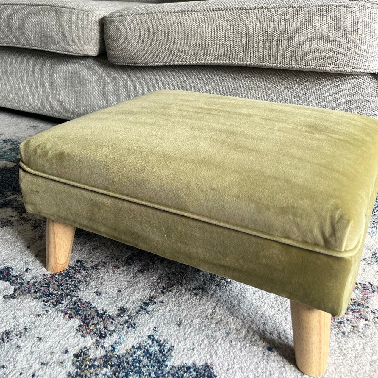 Low olive plush velvet footstool with piping trim for footrest 
