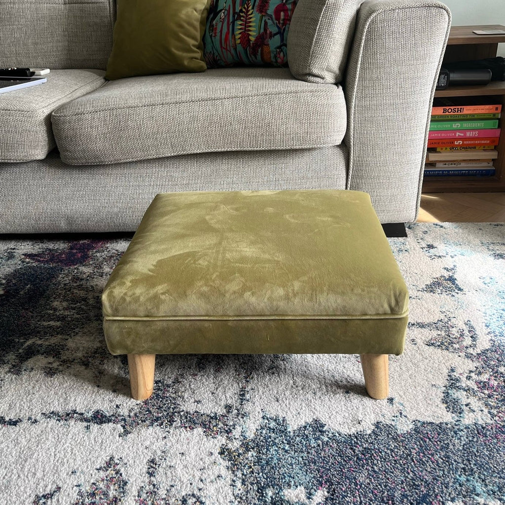 Small olive velvet footrest with wooden feet