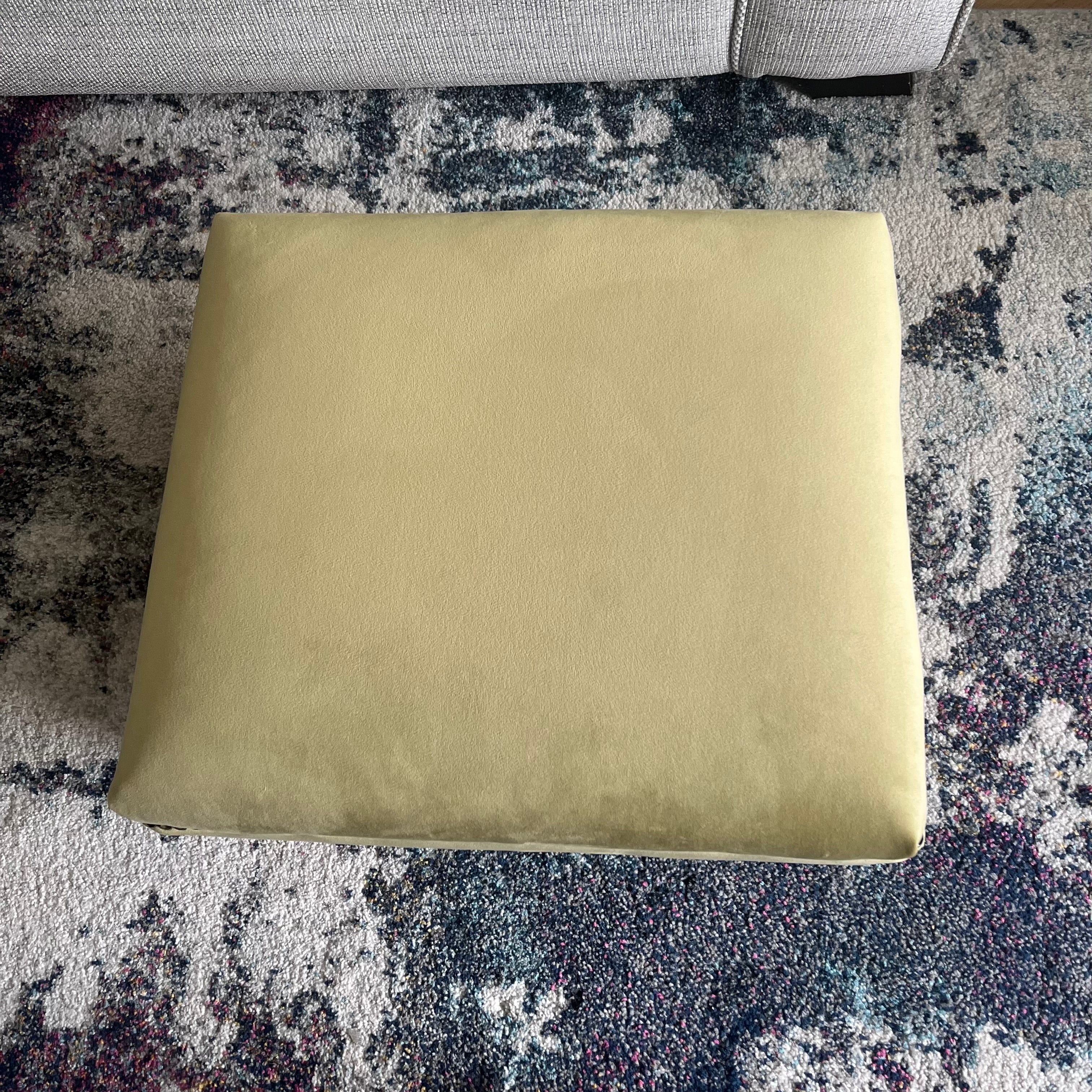 small olive green foot rest and stool with piping trim