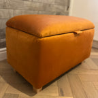 burnt orange bright ottoman storage chest with wooden legs