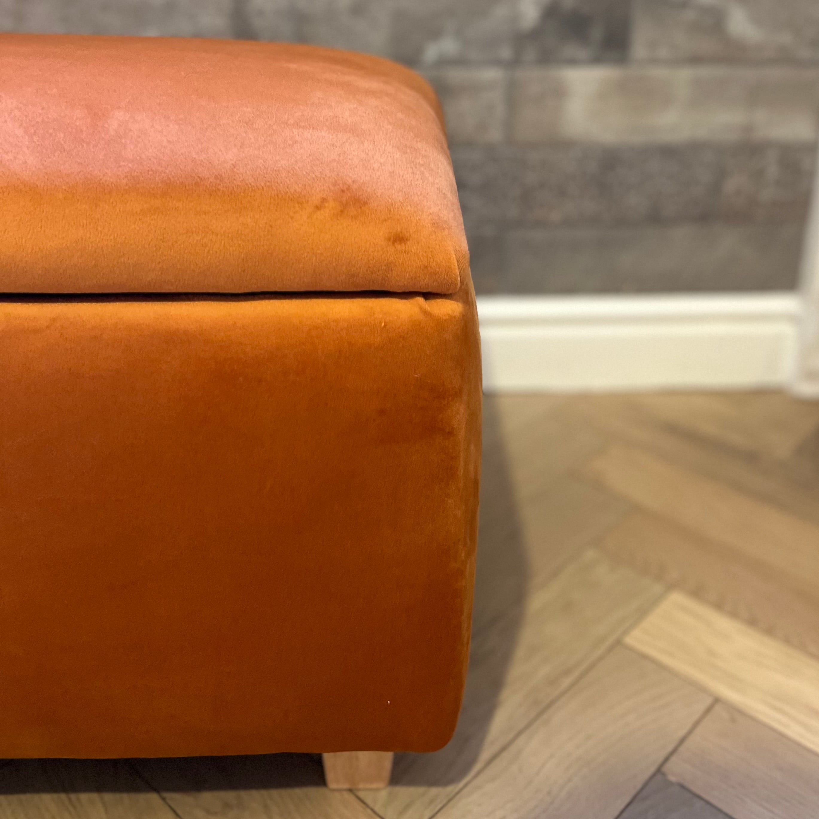 burnt orange storage box footstool with a lid and wooden feet