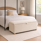 Bedroom with a canopy bed, ottoman, and lamp.