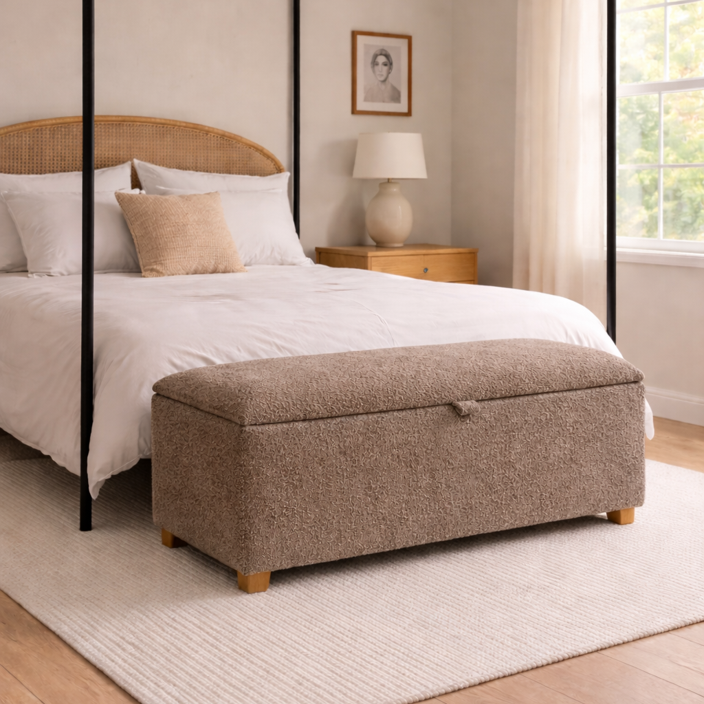 Bedroom with a four-poster bed and a brown ottoman.