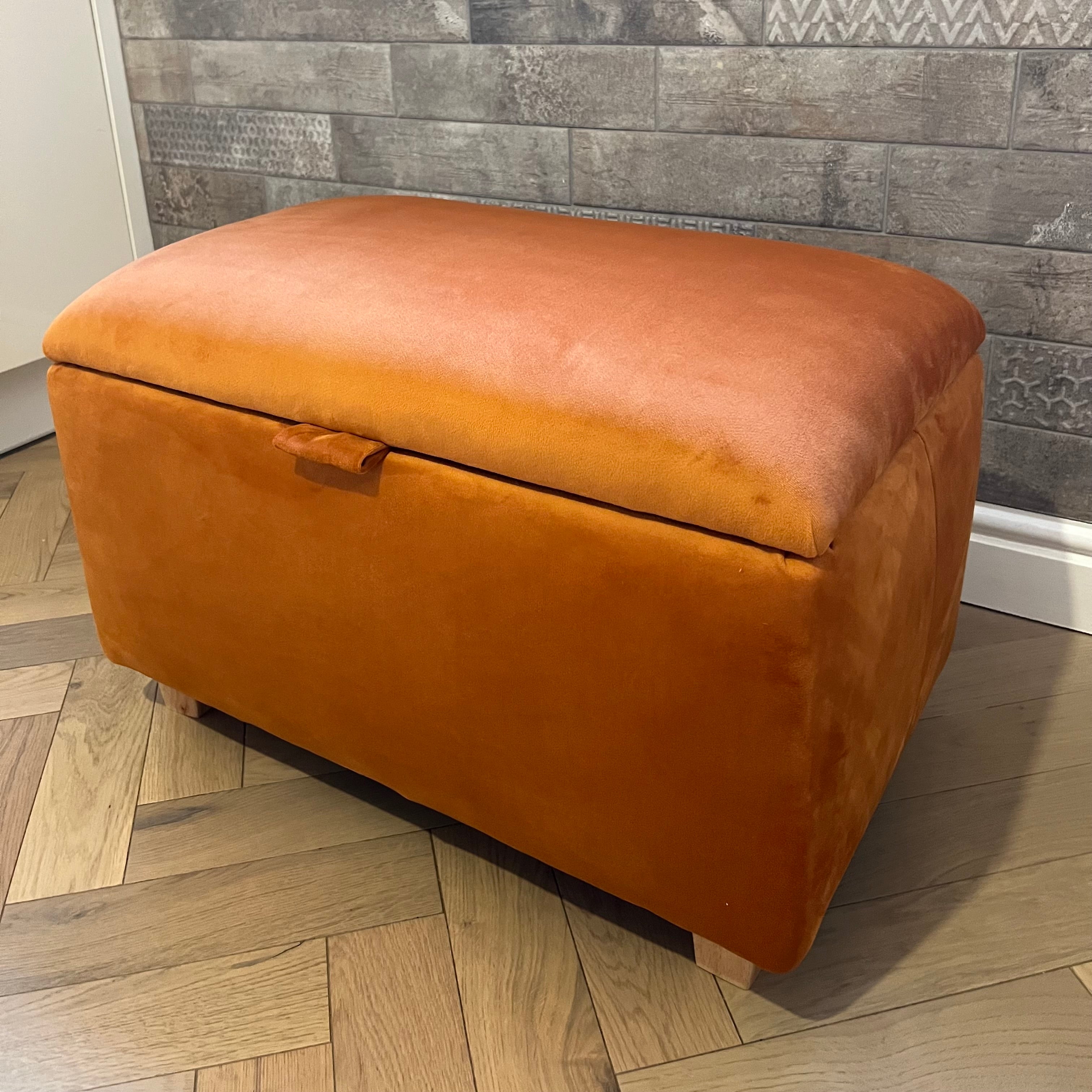 corner of burnt orange bright plush velvet storage ottoman box coffee table with wood trapeze feet