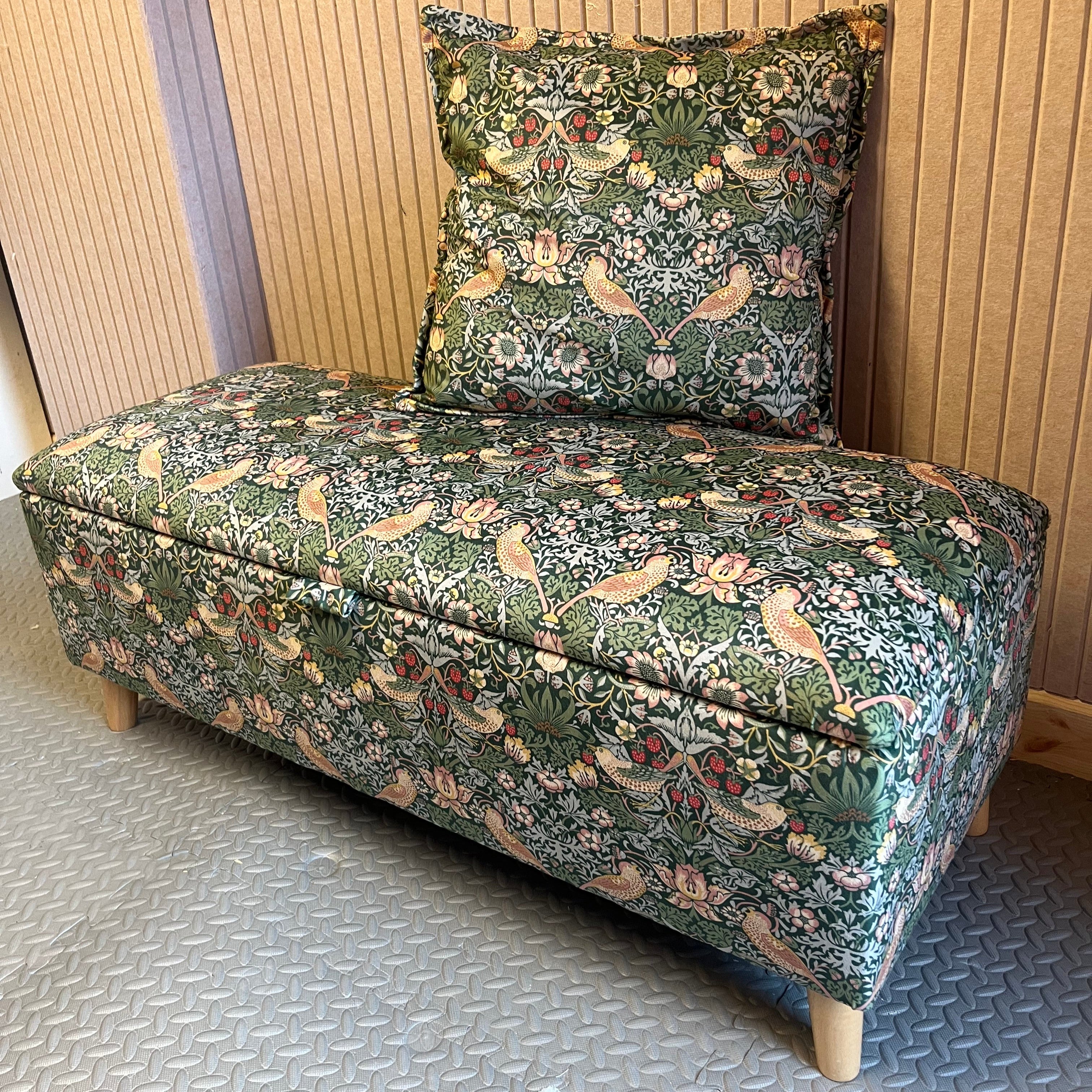 Green patterned cushion with a textured wall and matching green pattern bench seat